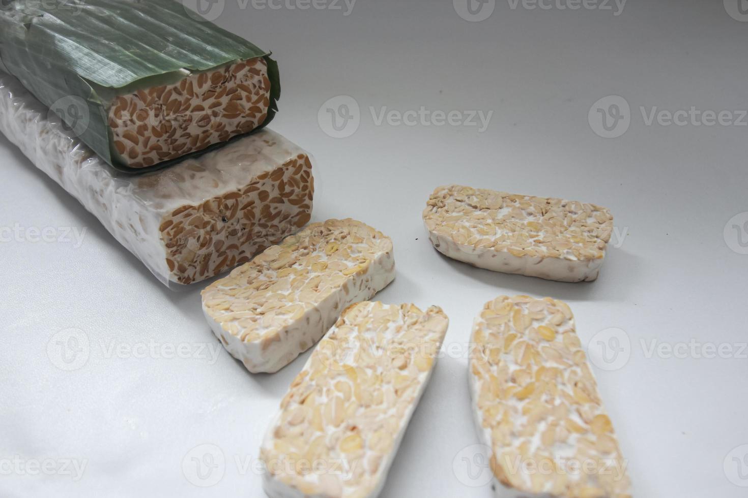 Tempeh Or Tempe is Indonesian traditional food made from fermented soybeans. They are usually wrapped in banana leaves photo