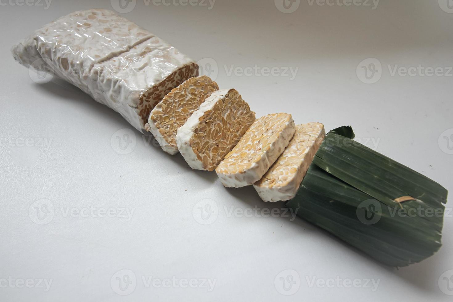 Tempeh Or Tempe is Indonesian traditional food made from fermented soybeans. They are usually wrapped in banana leaves photo