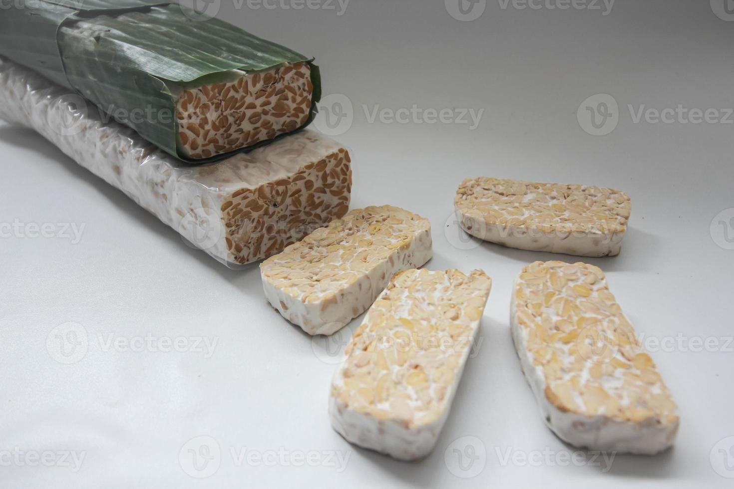 Tempeh Or Tempe is Indonesian traditional food made from fermented soybeans. They are usually wrapped in banana leaves photo
