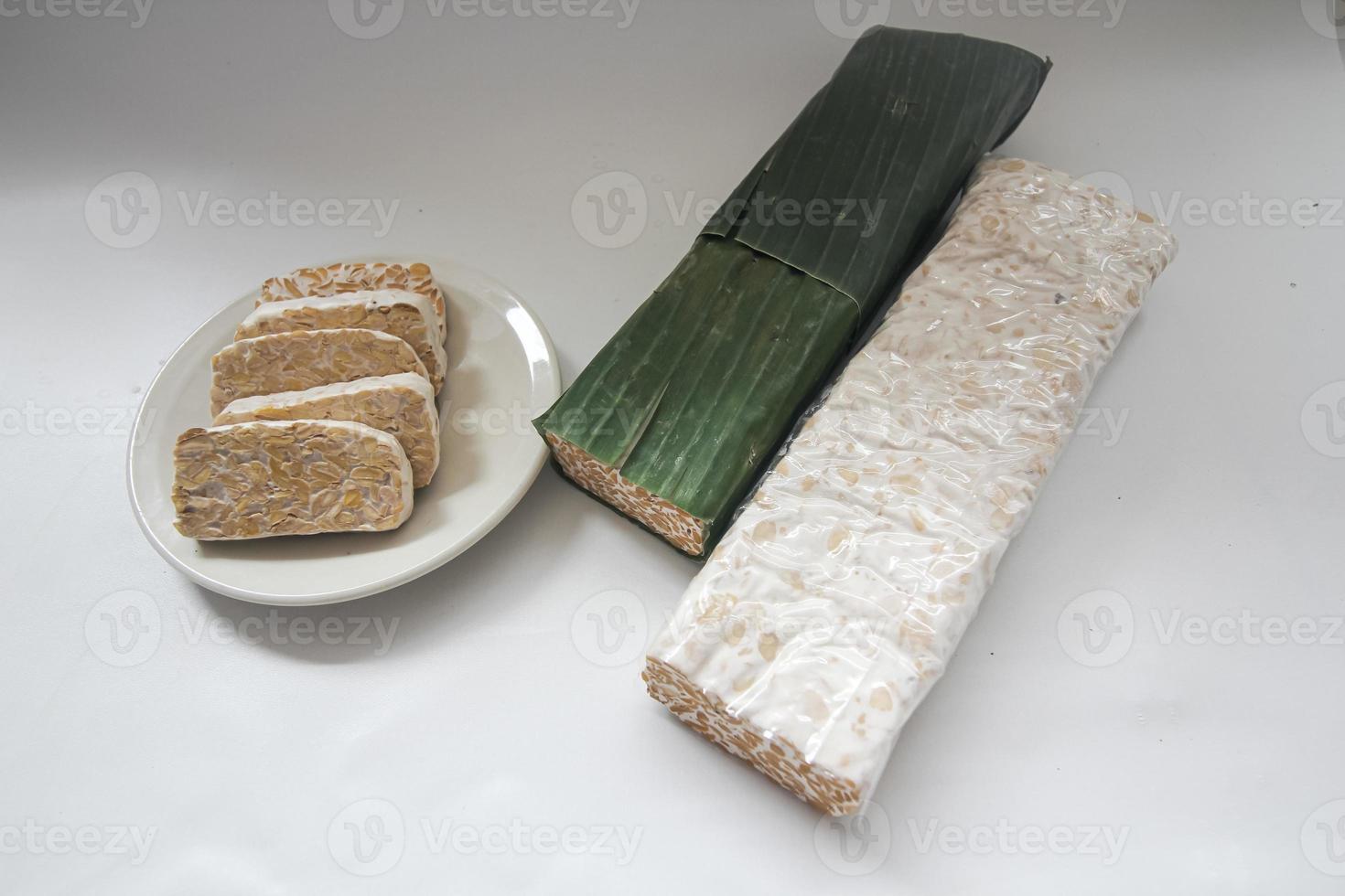 Tempeh Or Tempe is Indonesian traditional food made from fermented soybeans. They are usually wrapped in banana leaves photo