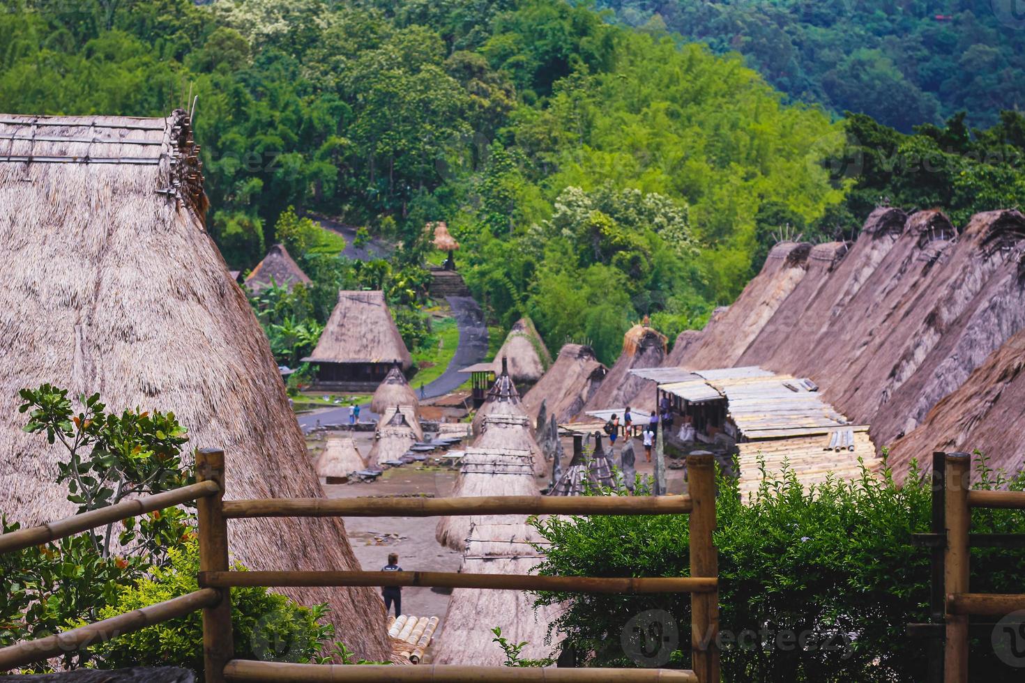Bena a traditional village with grass huts of the Ngas people in Flores near Bajawa, Indonesia. Many small houses are made of natural parts like wood and straw. Giant volcano in the back photo