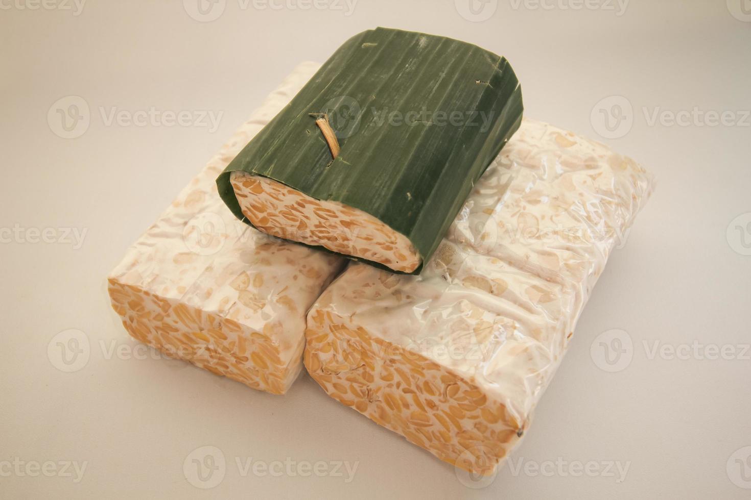 Tempeh Or Tempe is Indonesian traditional food made from fermented soybeans. They are usually wrapped in banana leaves photo