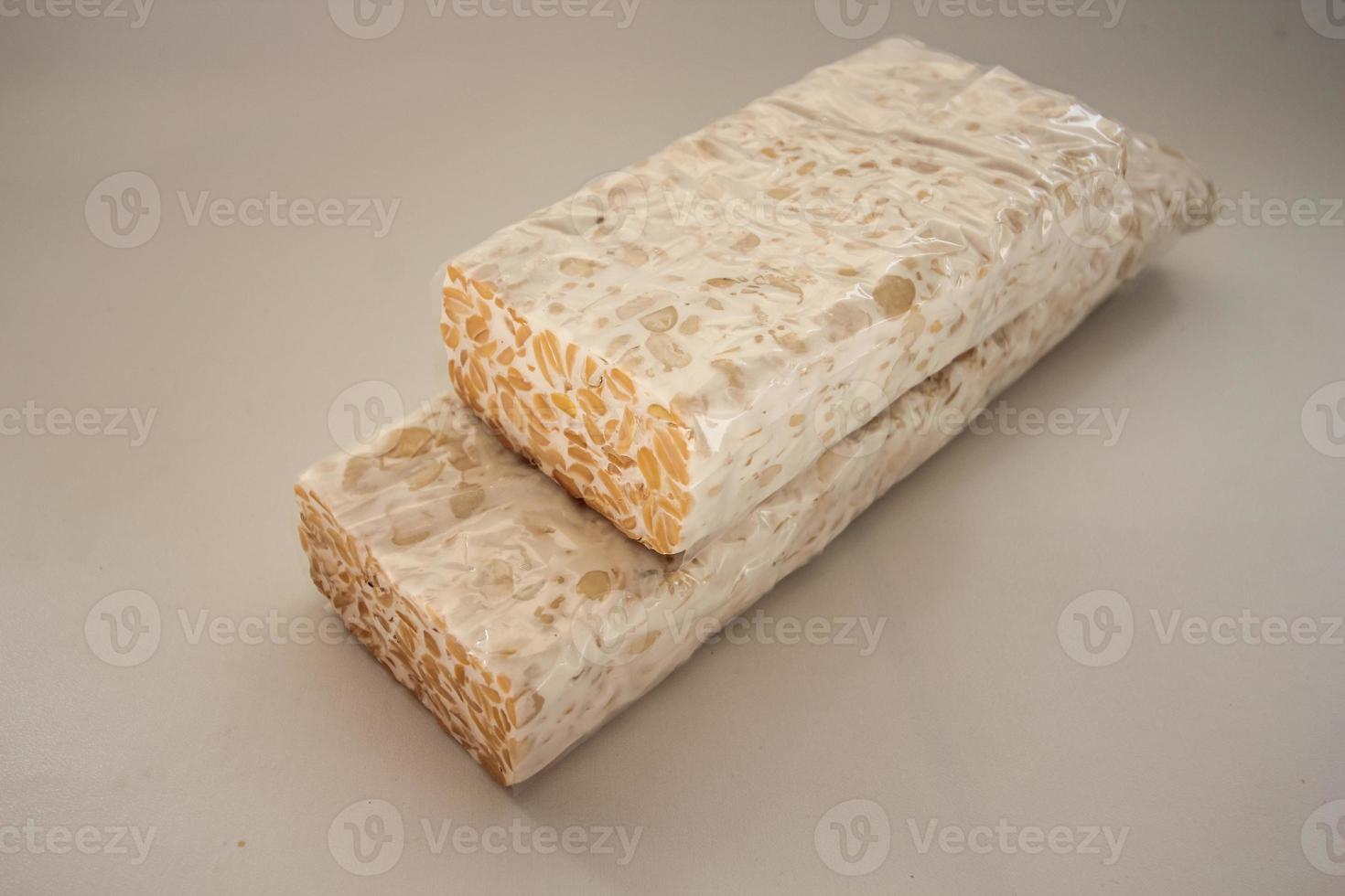 Tempeh Or Tempe is Indonesian traditional food made from fermented soybeans. They are usually wrapped in banana leaves photo