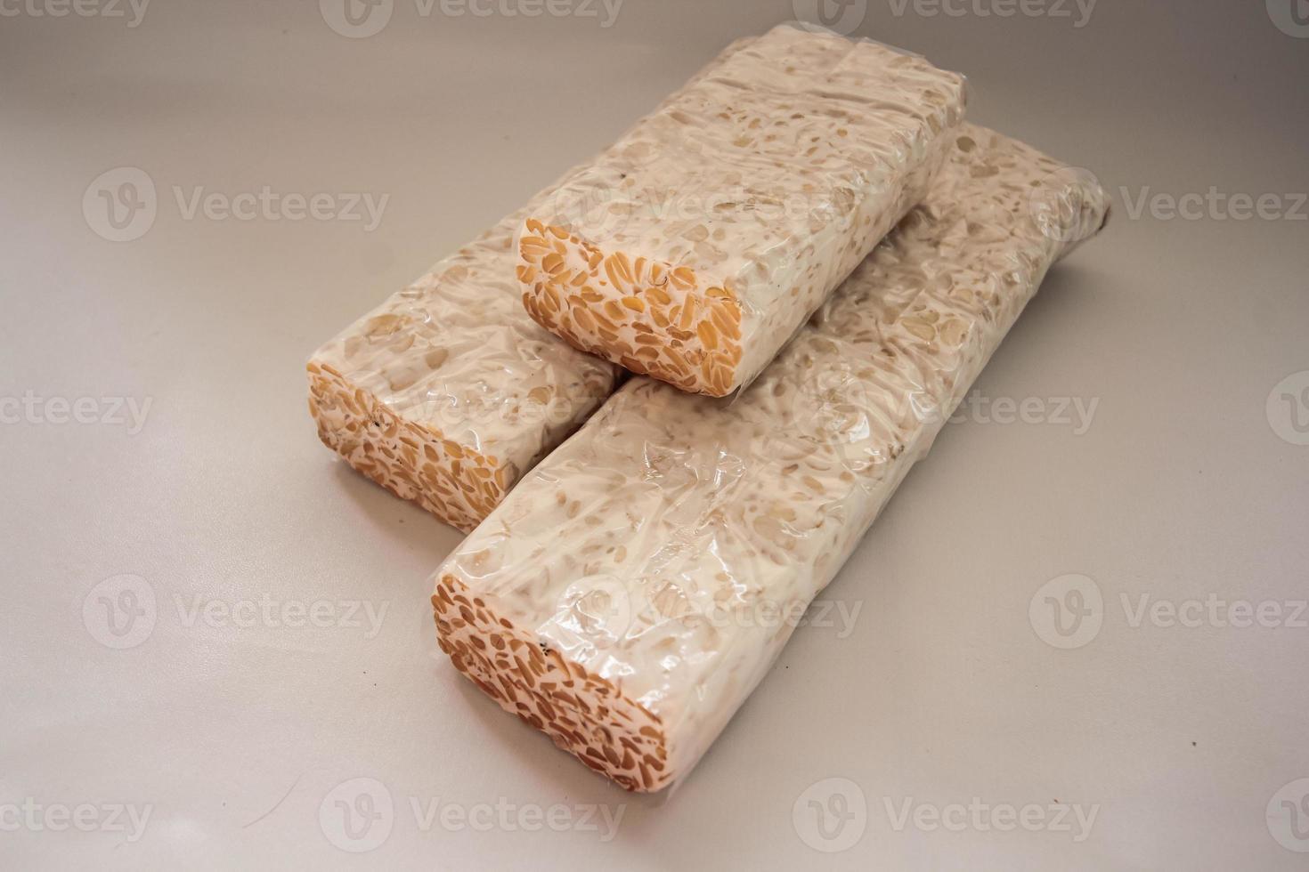 Tempeh Or Tempe is Indonesian traditional food made from fermented soybeans. They are usually wrapped in banana leaves photo