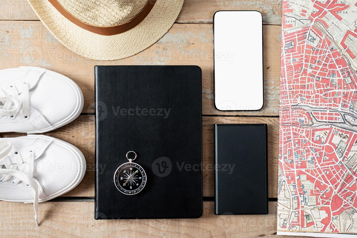 traveler accessories with map, devices and clothes on white background photo