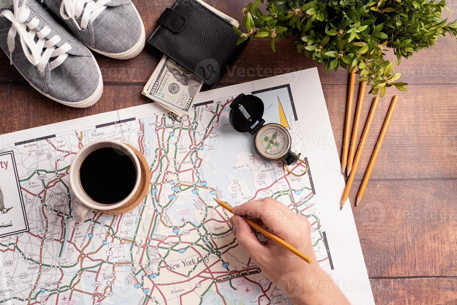 man hand drawing on travel map, planning trip or vacation photo