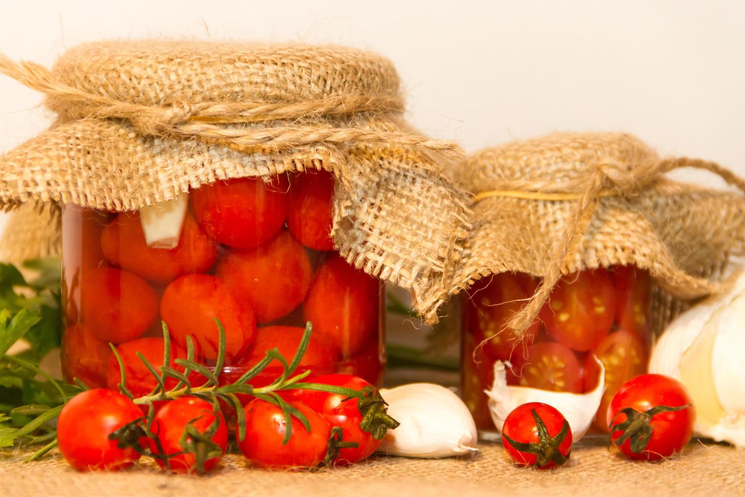 pickled cherry tomatoes in vinegar with garlic and spices photo