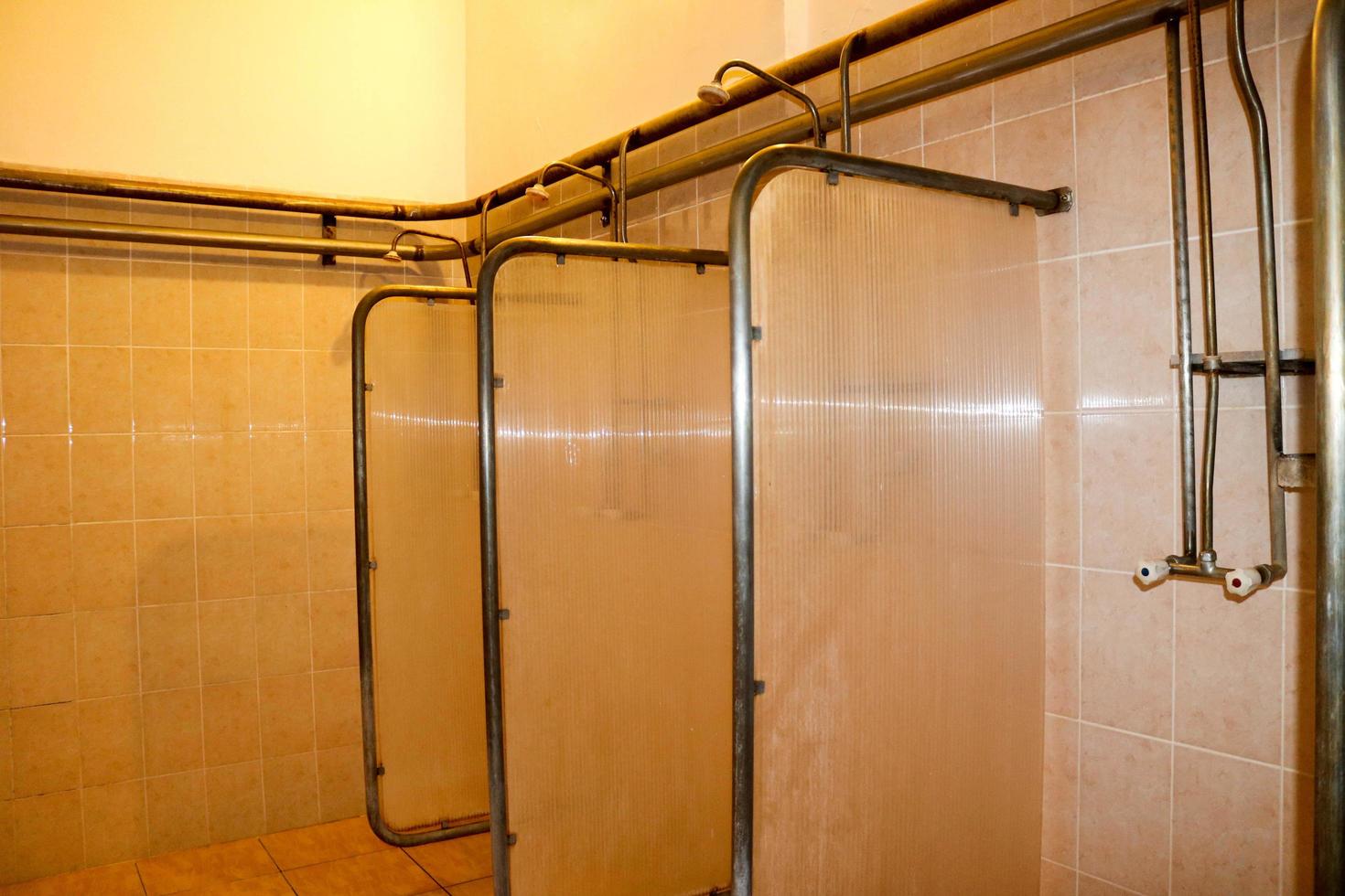Shower cabins in the dressing rooms of workers at the industrial plant photo