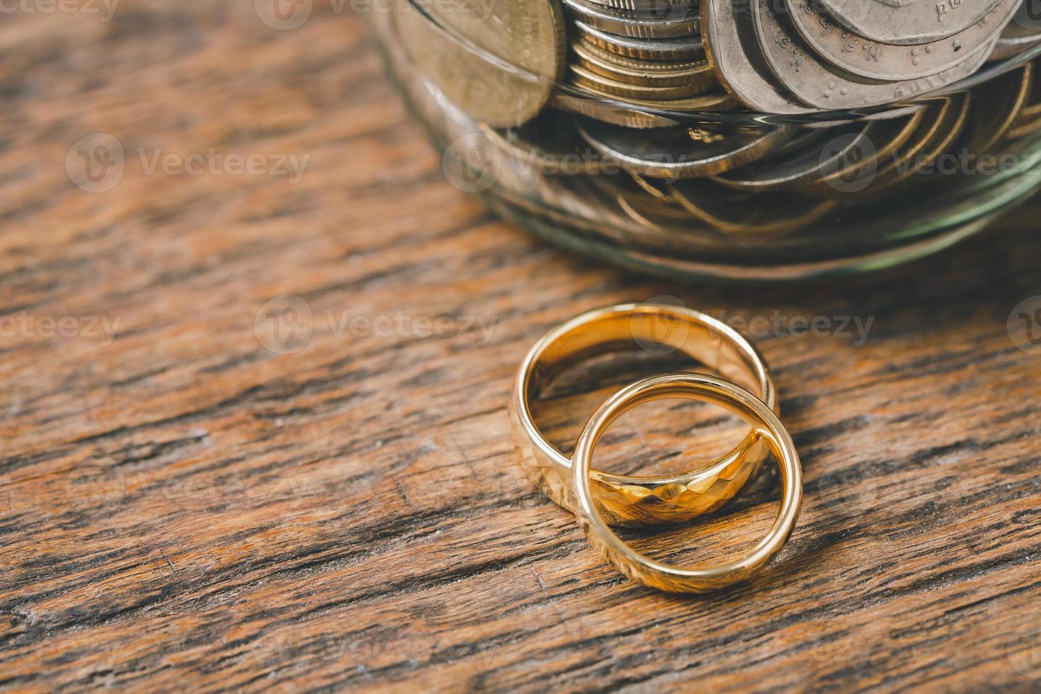 Save money and planning wedding concept. Sustainable financial goal for family life or married life. Rings with stack of coins, saving money for marry, depicts savings or growth for new family. photo