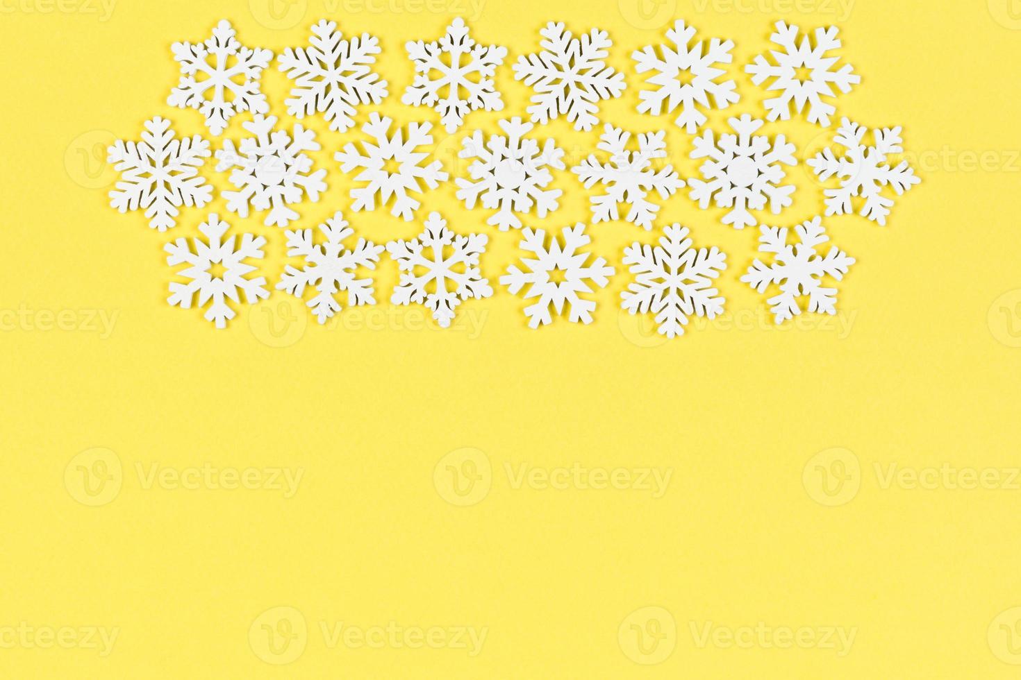 Top view of winter ornament made of white snowflakes on colorful background. Happy New Year concept with copy space photo
