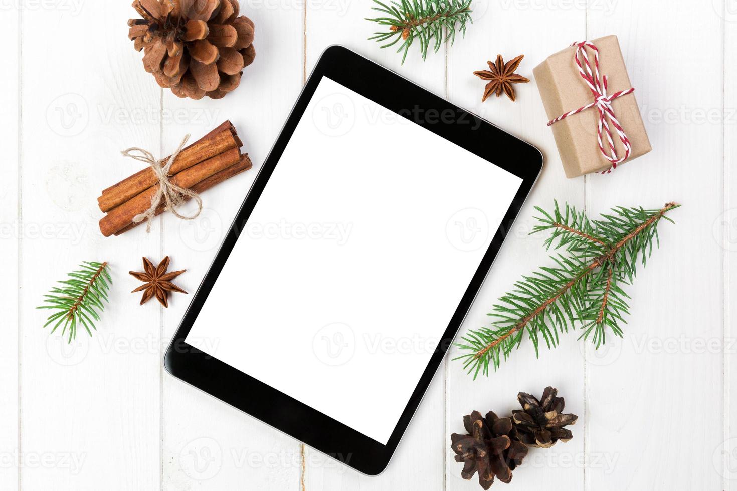 Digital tablet mock up with rustic Christmas wooden background decorations for app presentation. top view with copy space photo