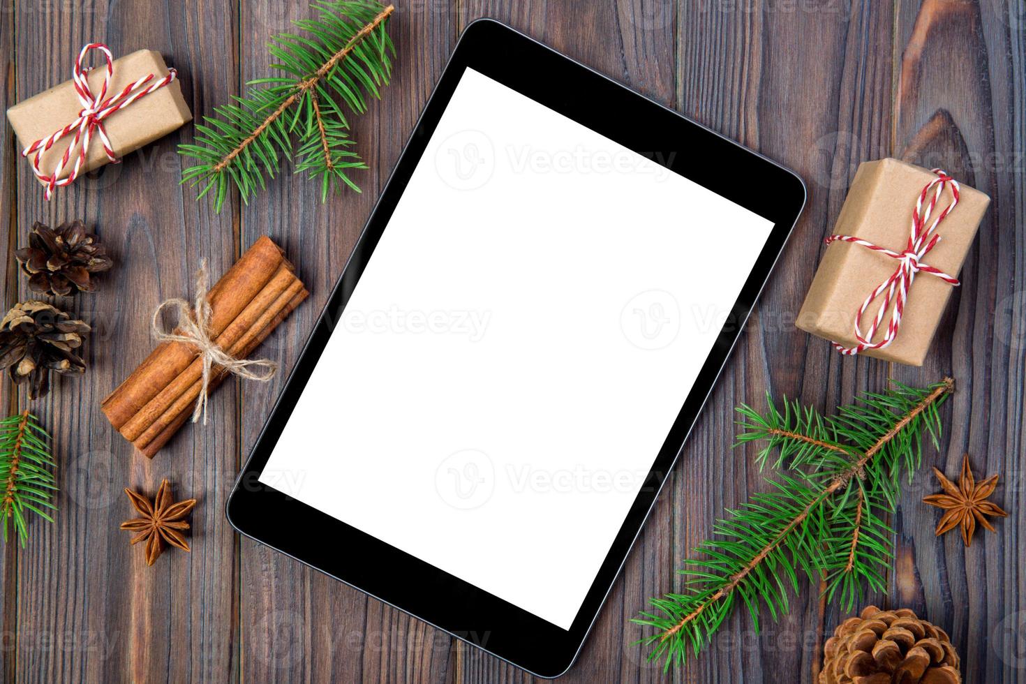 Digital tablet mock up with rustic Christmas wooden background decorations for app presentation. top view with copy space photo