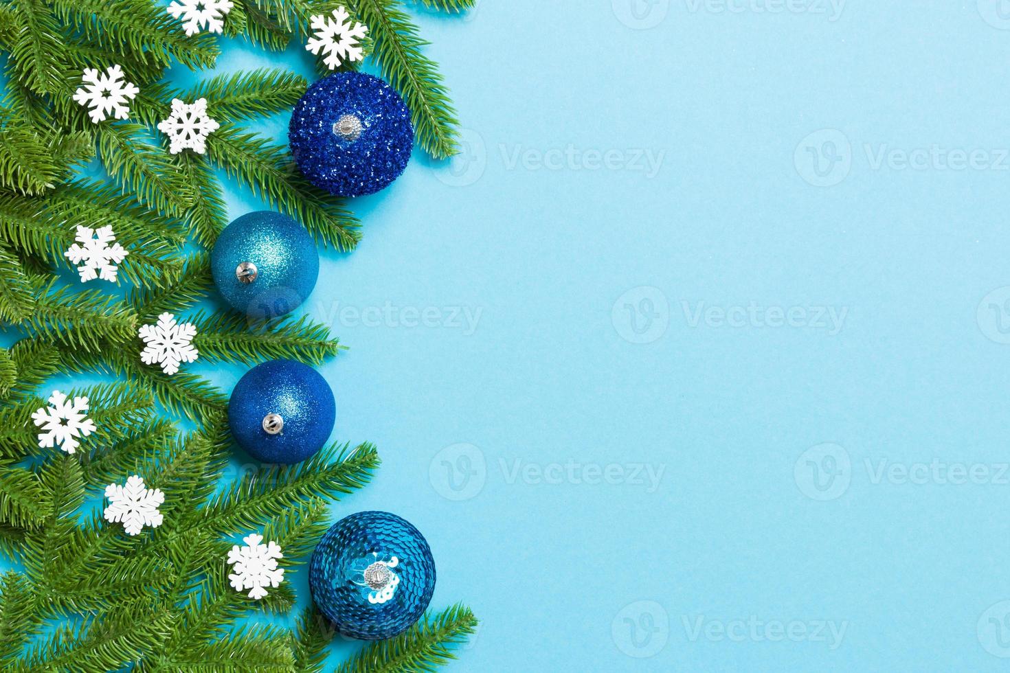Christmas composition made of fir tree, balls and different decorations on colorful background. Top view of New Year Advent concept with empty space for your design photo