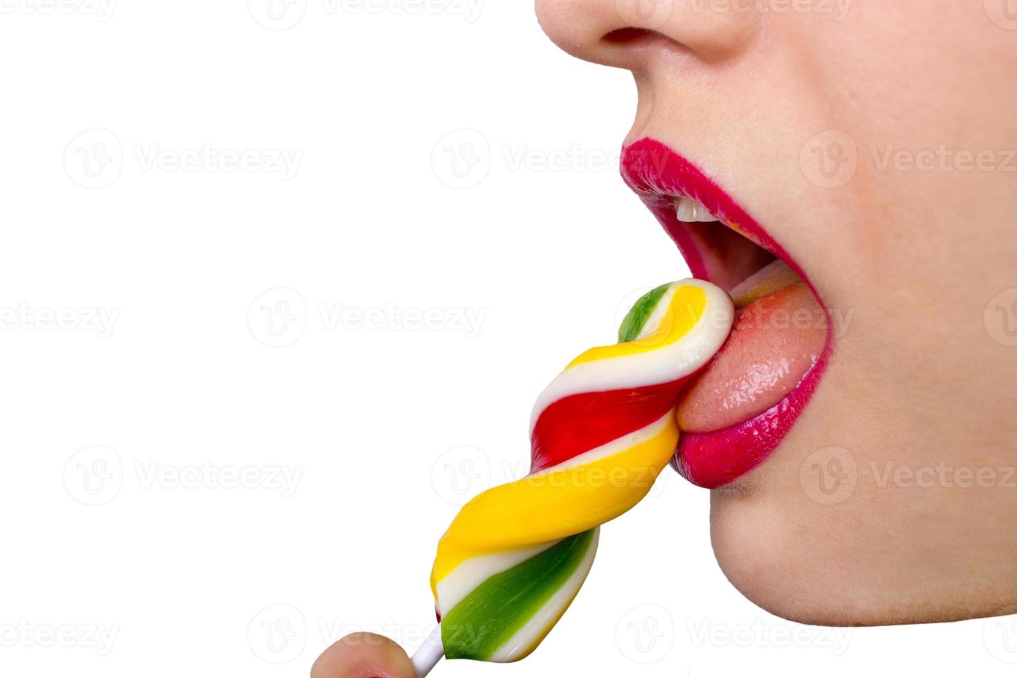 Sexy woman with red lips holding lollipop photo