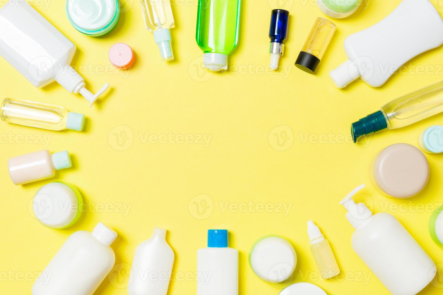 Frame of plastic bodycare bottle Flat lay composition with cosmetic products on yellow background empty space for you design. Set of White Cosmetic containers, top view with copy space photo