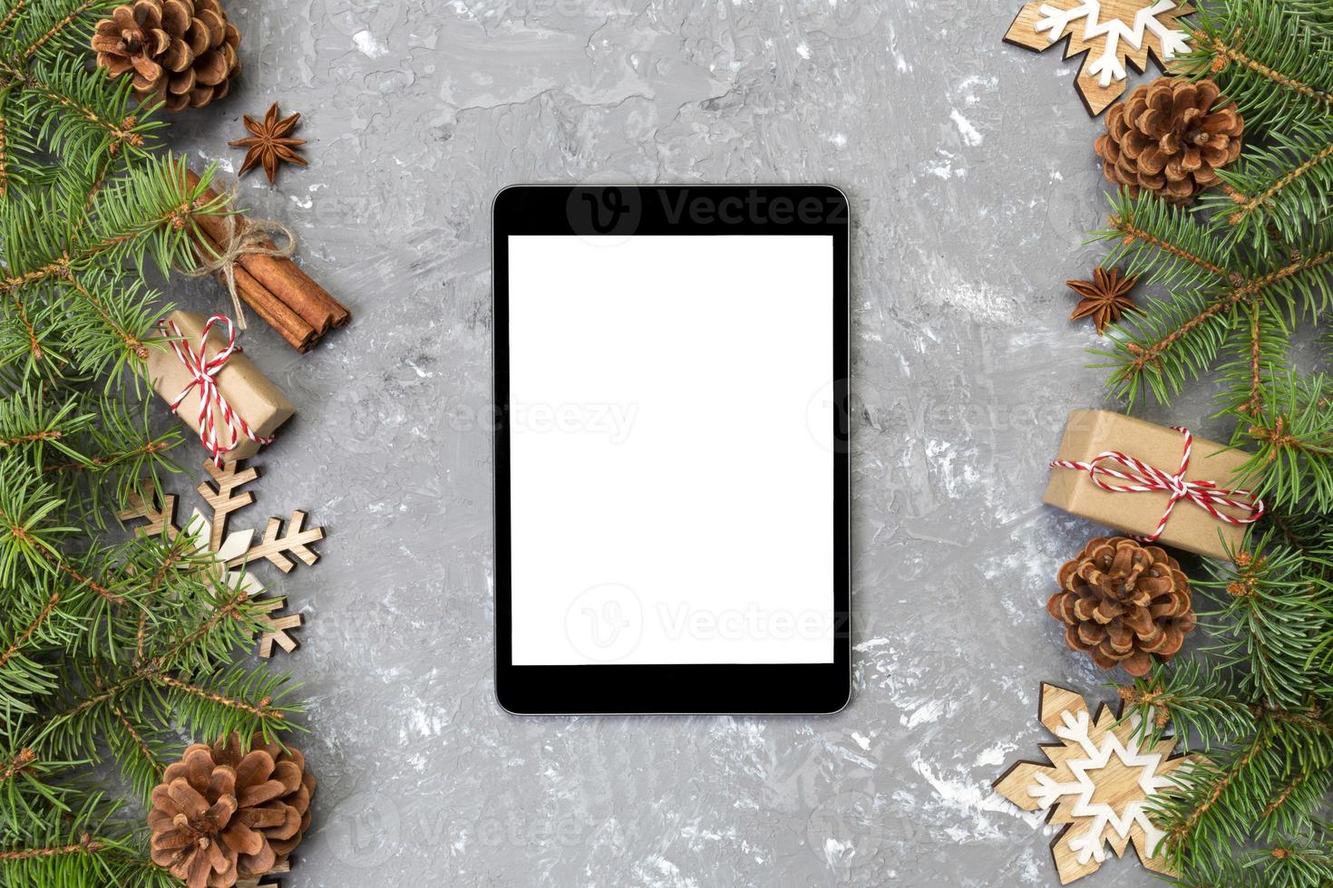 Digital tablet mock up with rustic Christmas gray cement background decorations for app presentation. top view with copy space photo