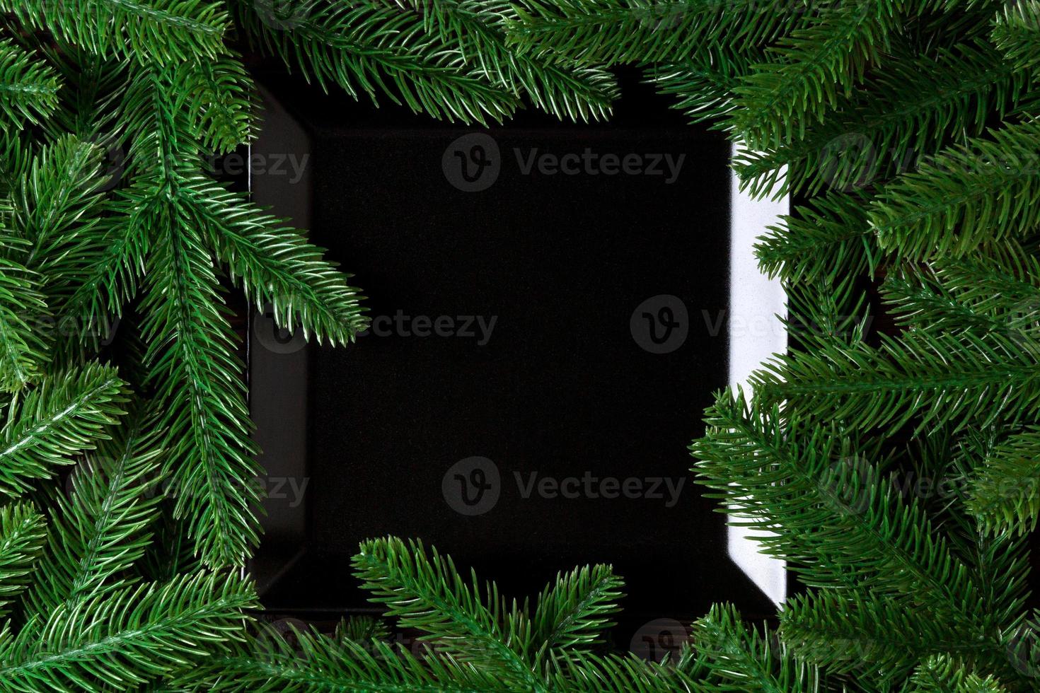 Top view served plate with green fir tree branches. Holiday dinner concept with copy space photo