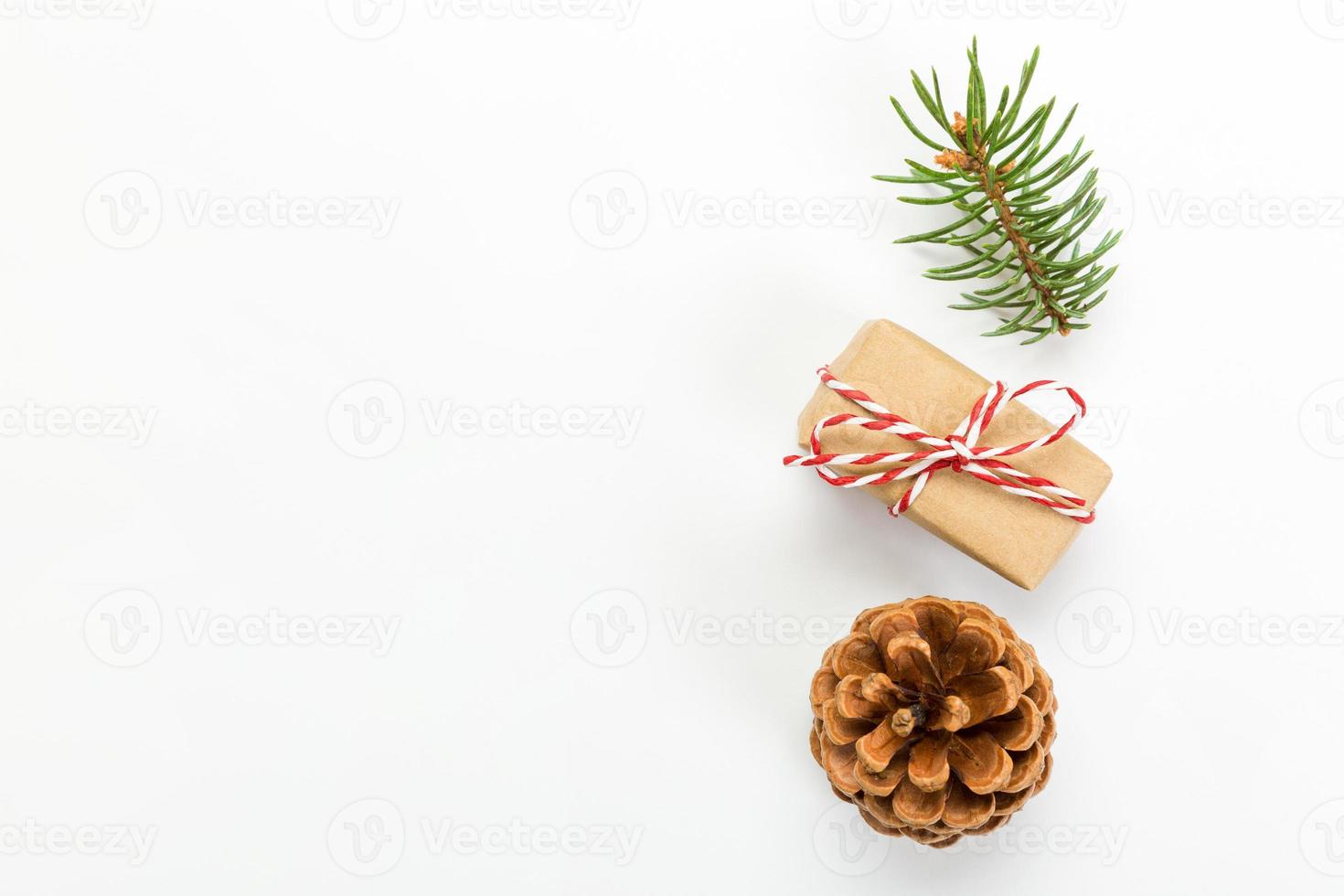 Christmas composition with pine cones fir tree branches and christmas gift box. Top view, flat lay on white background photo