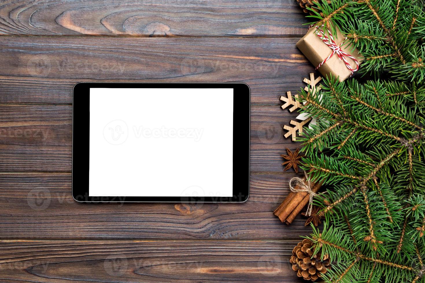 Digital tablet mock up with rustic Christmas wood background decorations for app presentation. top view with copy space photo