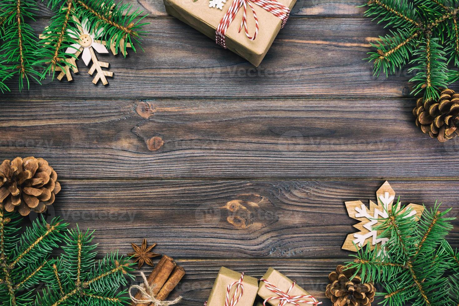 Christmas vintage, toned background with fir tree and gift box on wooden table. Top view with copy space for your design photo