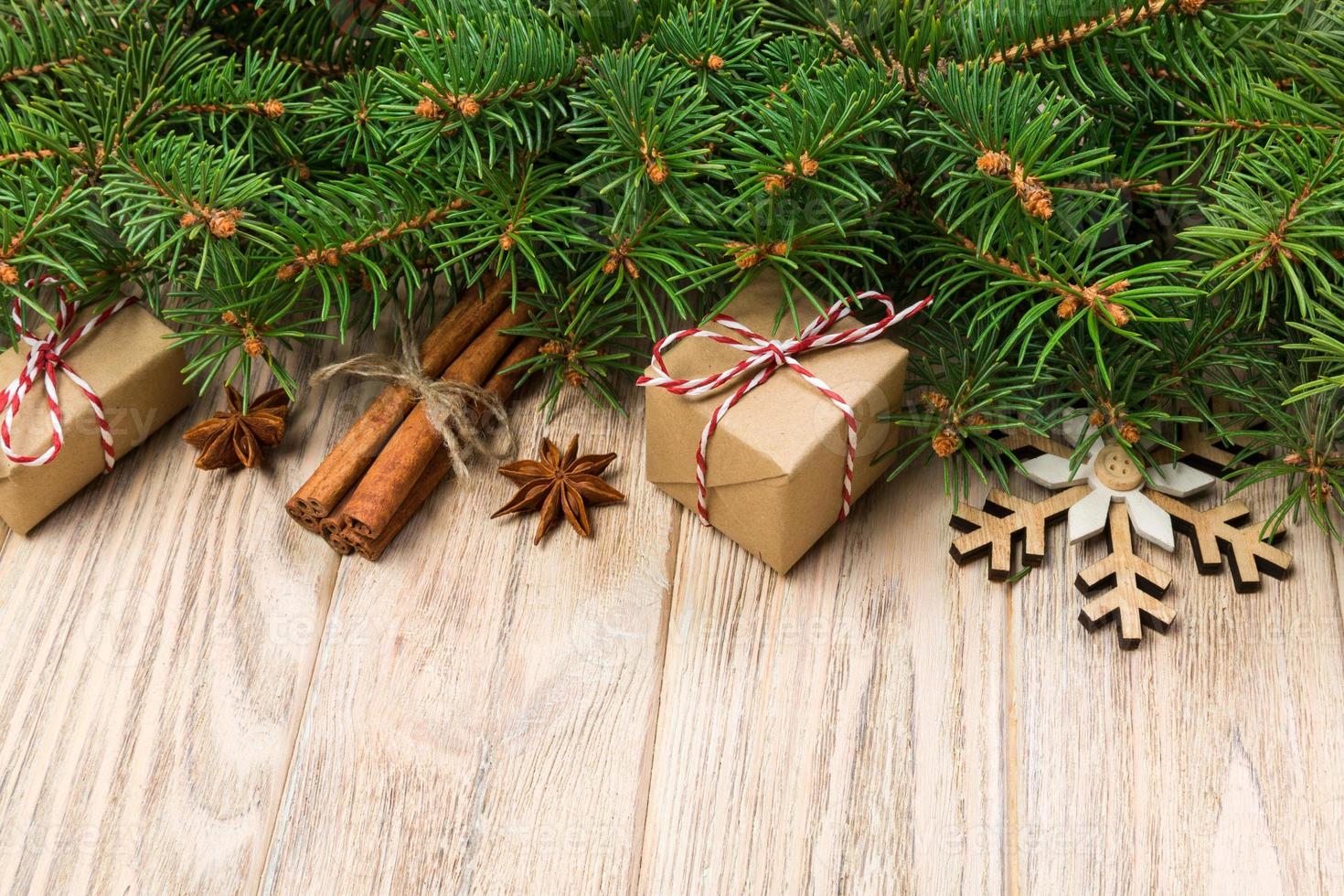 Christmas background with fir tree and gift box on wooden table. Top view with copy space for your design photo
