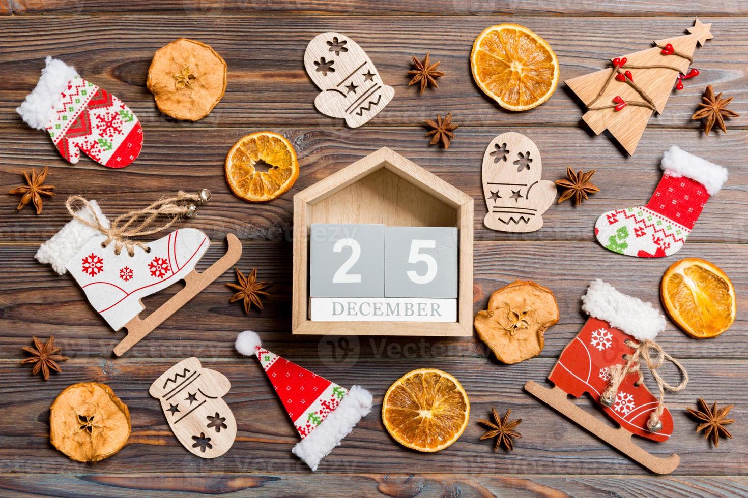 Top view of calendar on Christmas wooden background. The twenty fifth of December. New Year toys and decorations. Holiday concept photo