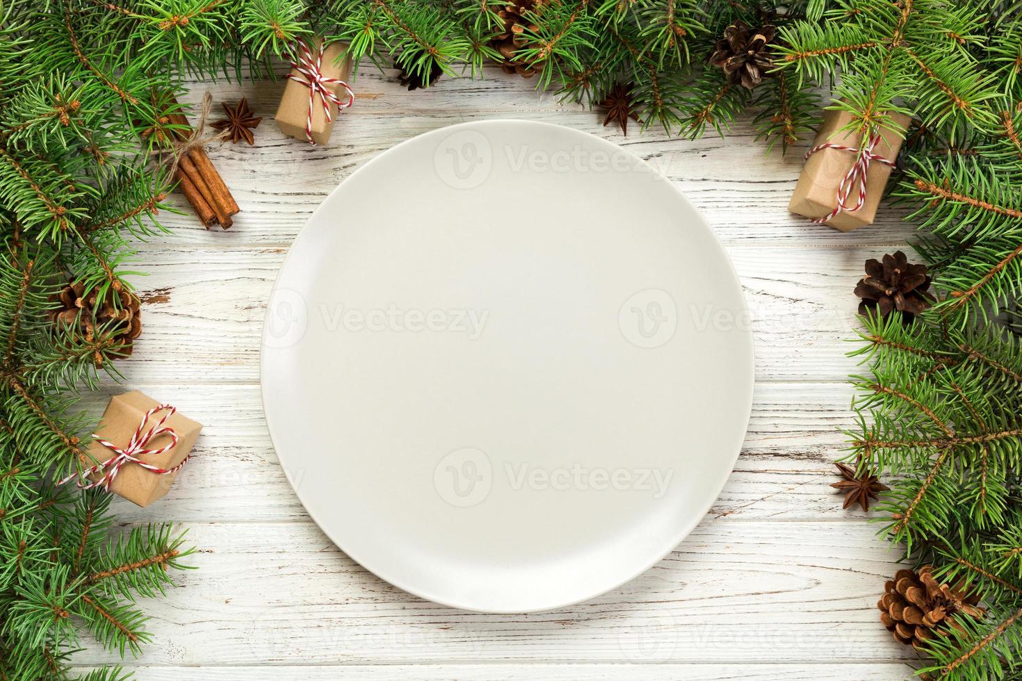 top view. Empty plate round ceramic on wooden christmas background. holiday dinner dish concept with new year decor photo
