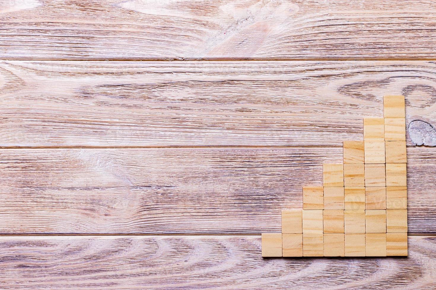 A wooden blocks cube over black wooden textured background with copy space for add word text title. Concept or conceptual Wood block stair or seven steps. Cubic photo