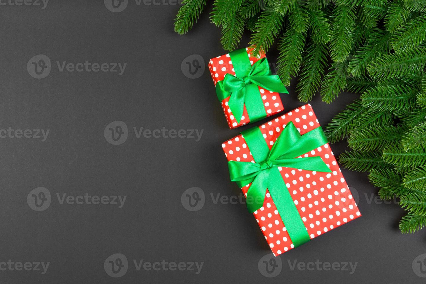 Top view of gift box and fir tree branches on colorful background. Merry Christmas concept with empty space for your design photo