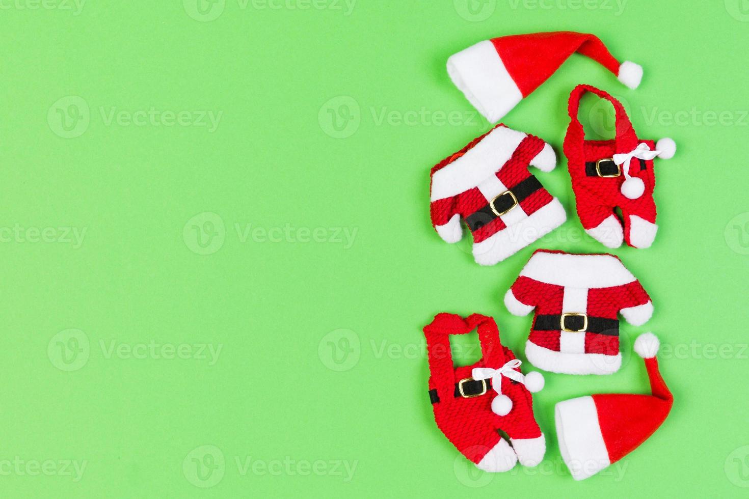 Top view od stylish red Santa hats on colorful background. Merry Christmas concept with copy space photo