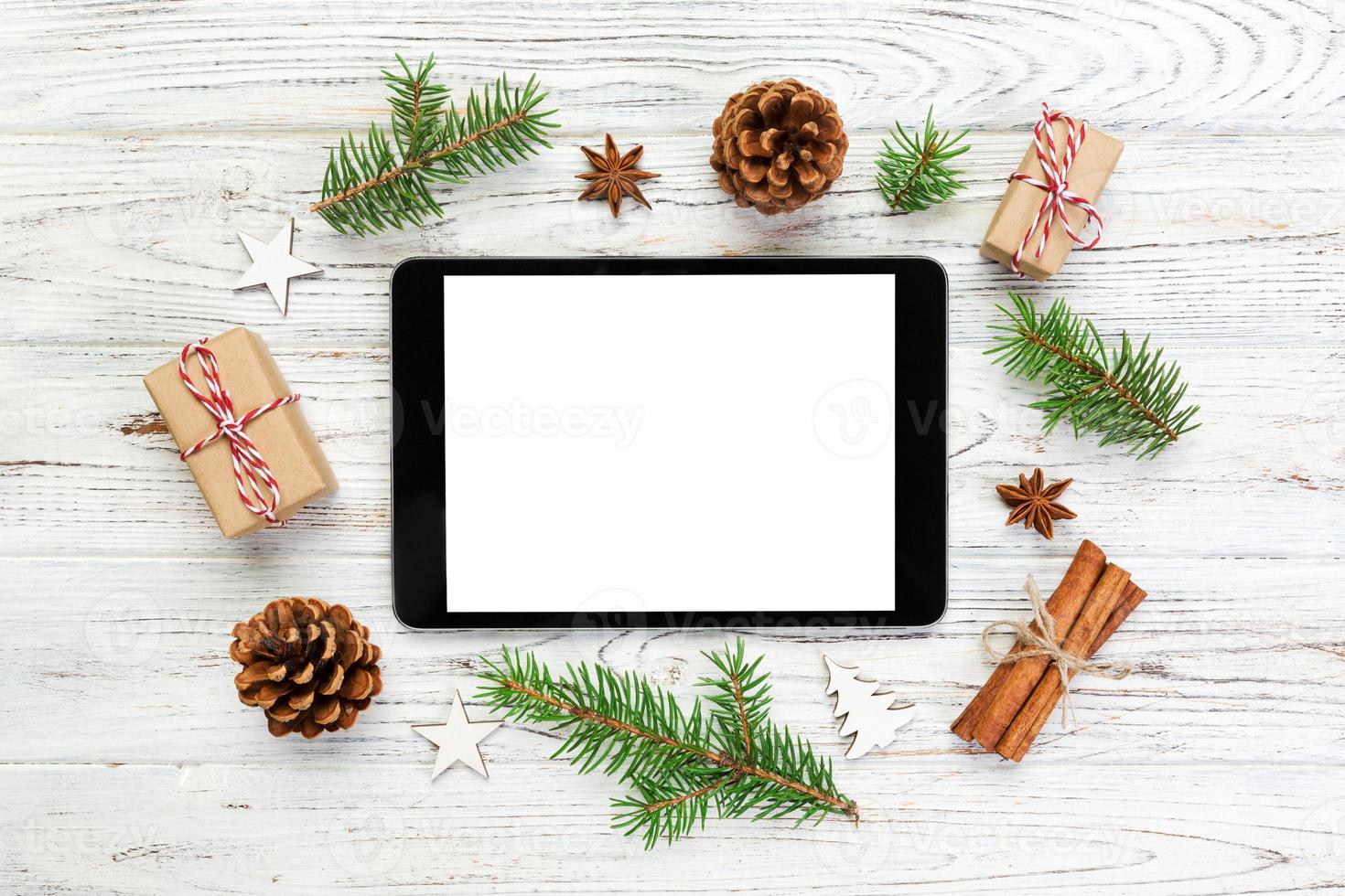 Digital tablet mock up with rustic Christmas wooden background decorations for app presentation. top view with copy space photo