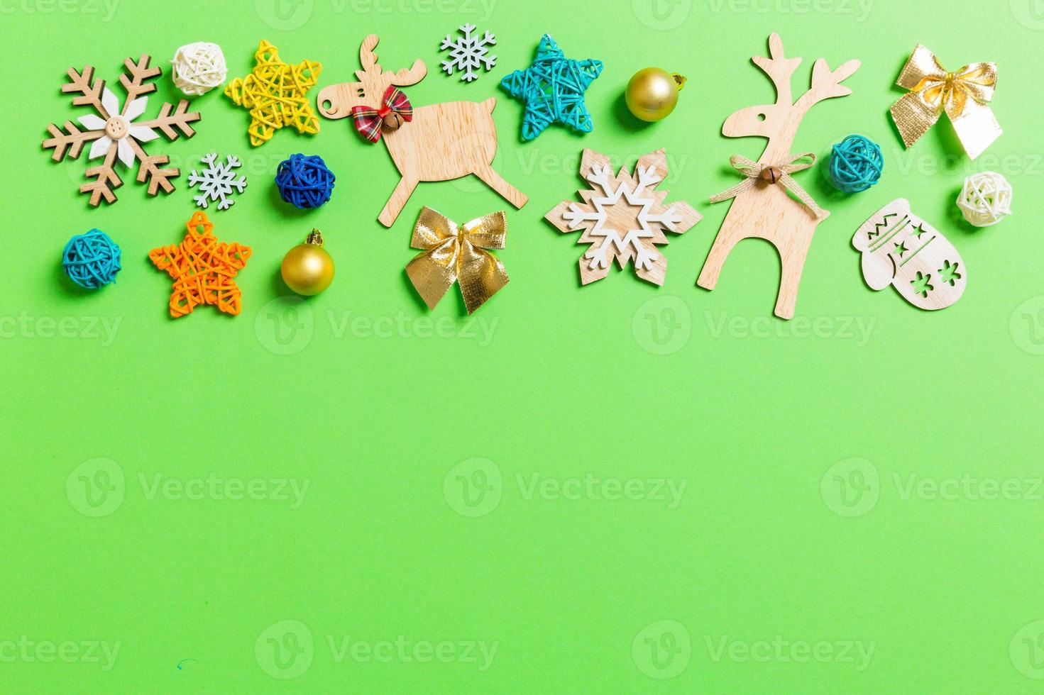 Top view of green background with New Year toys and decorations. Christmas time concept with copy space photo