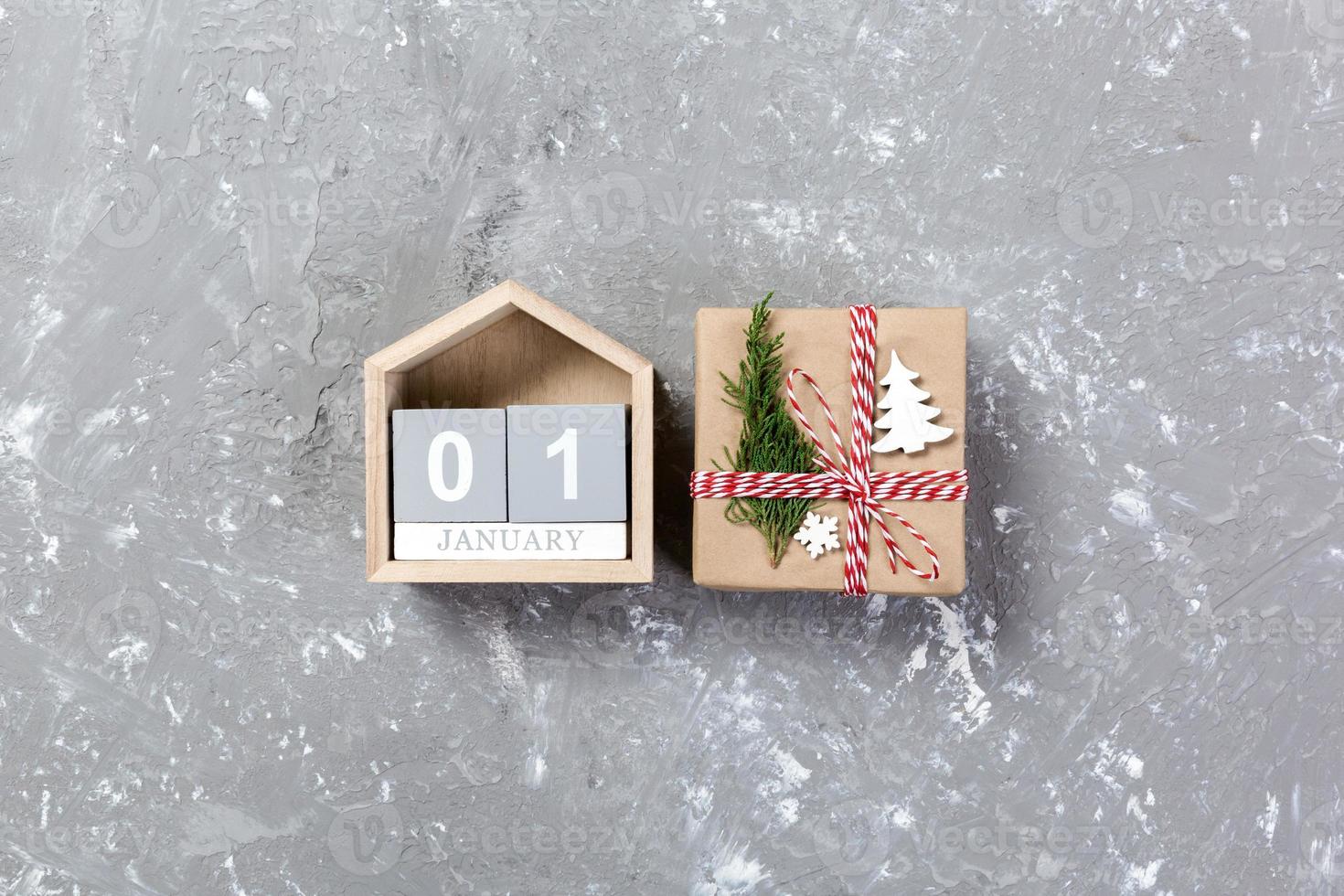 Calendar with date 1 january and gift boxes on color background. Christmas concept photo