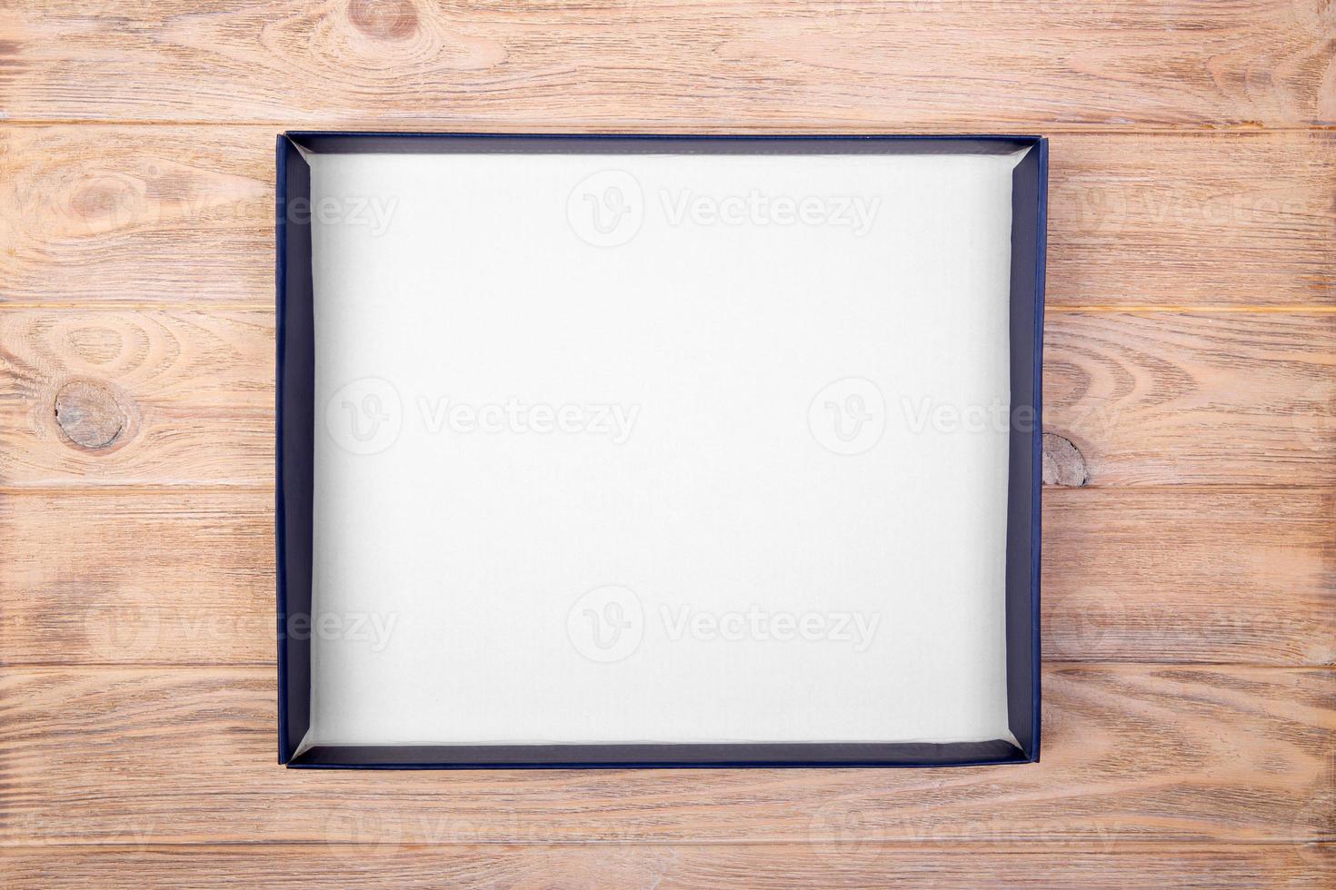 A empty blank white box on the desk table. top view photo