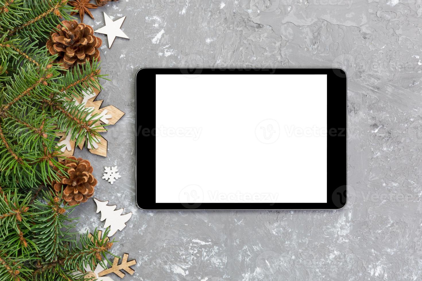 Digital tablet mock up with rustic Christmas gray cement background decorations for app presentation. top view with copy space photo