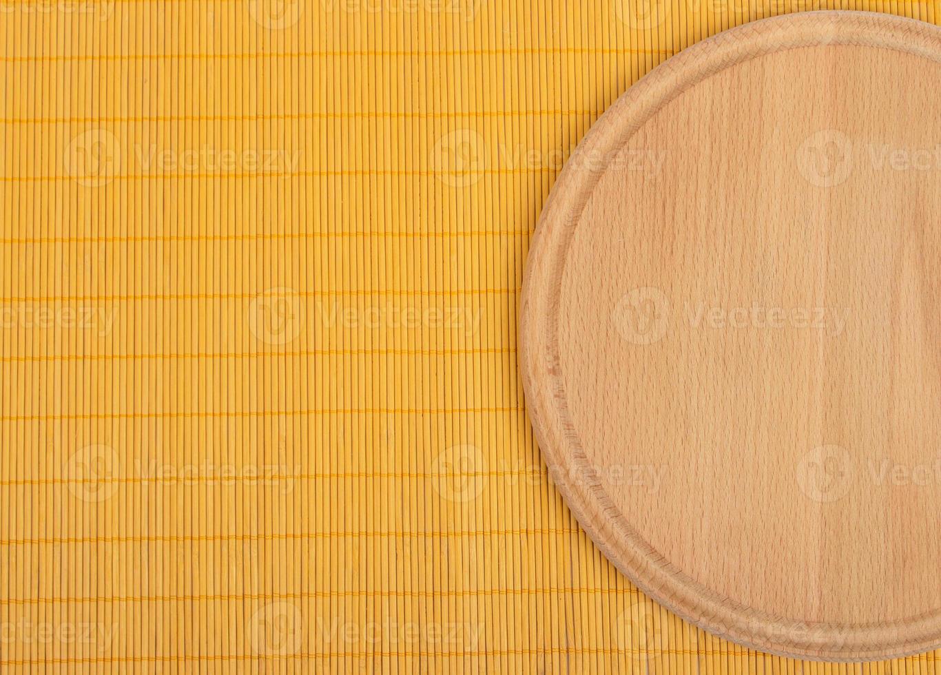 Empty round wooden board with tablecloth. photo