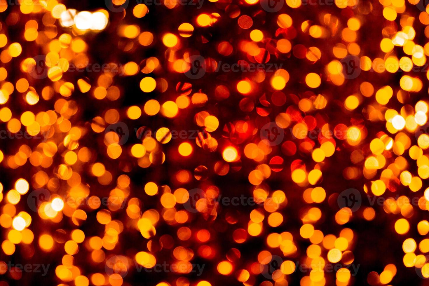 Unfocused abstract orange bokeh on black background. defocused and blurred many round light photo