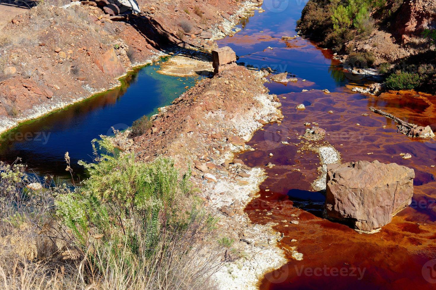 View of Mining activity in Minas de Riotinto in Spain. Polluted river, red and green color of water. Apocalypse scenery. Extractivism. Mining village in Andalusia. Destruction of nature. Mining indust photo