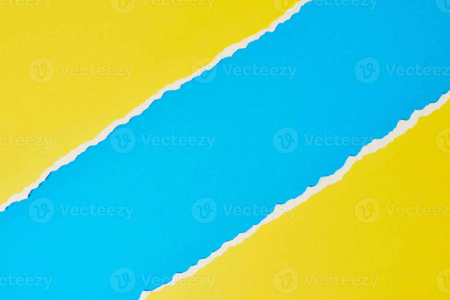 Torn ripped paper edge with a copy space, color blue and yellow background photo