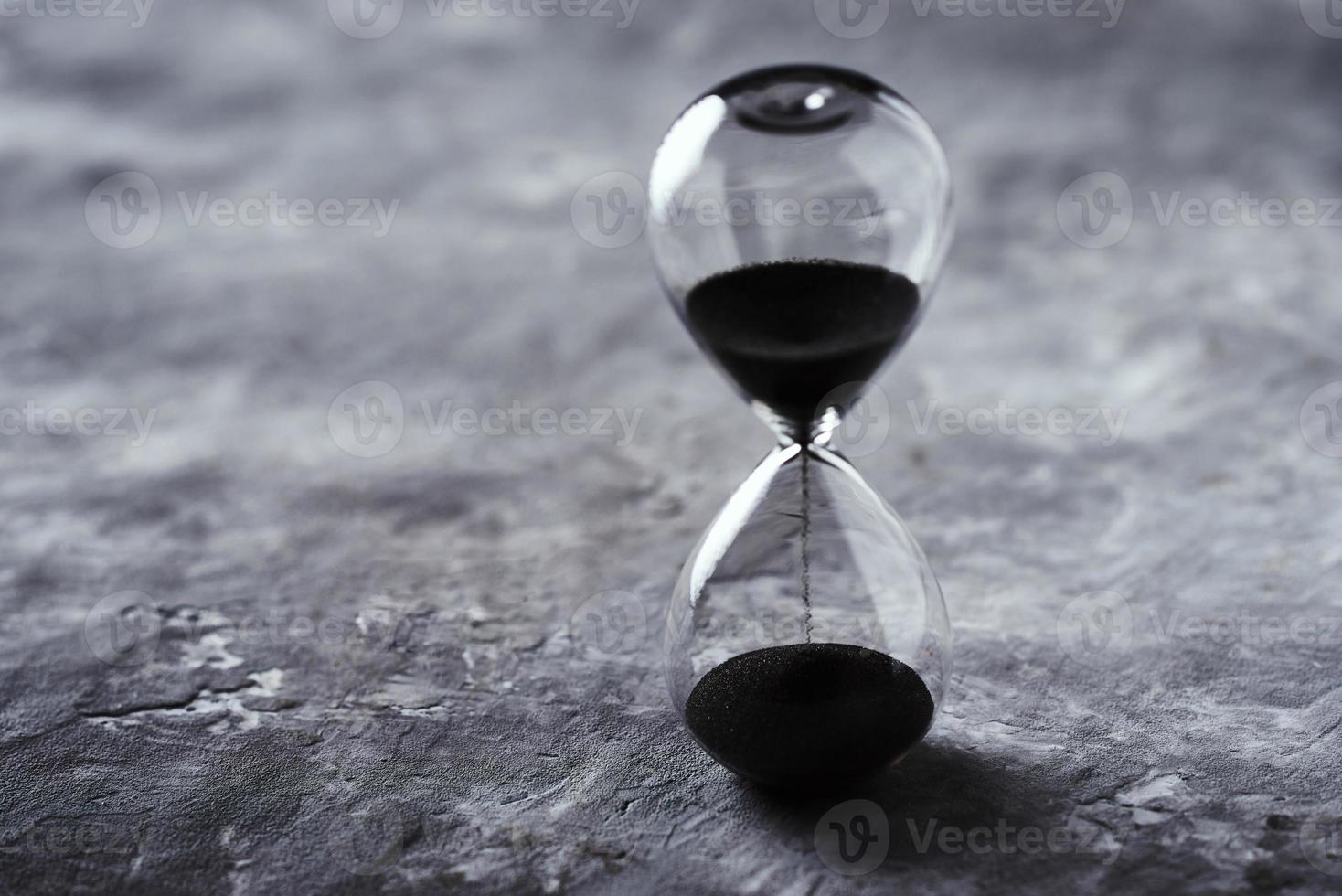 Hourglass on the dark background with copy space. photo