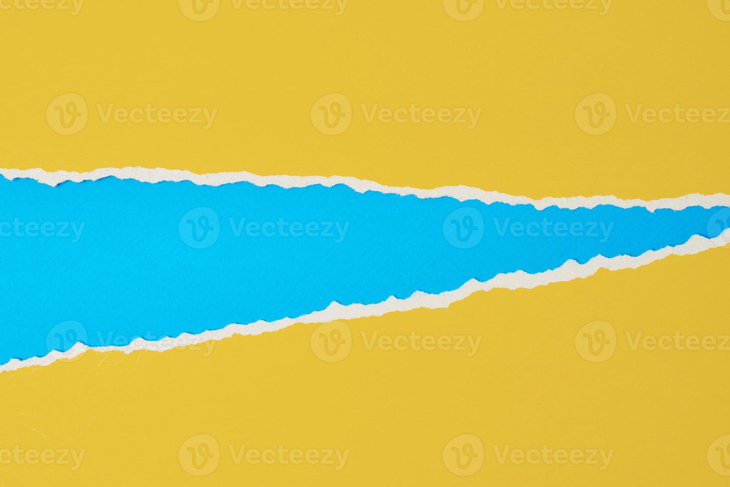 Torn ripped paper edge with a copy space, color blue and yellow background photo