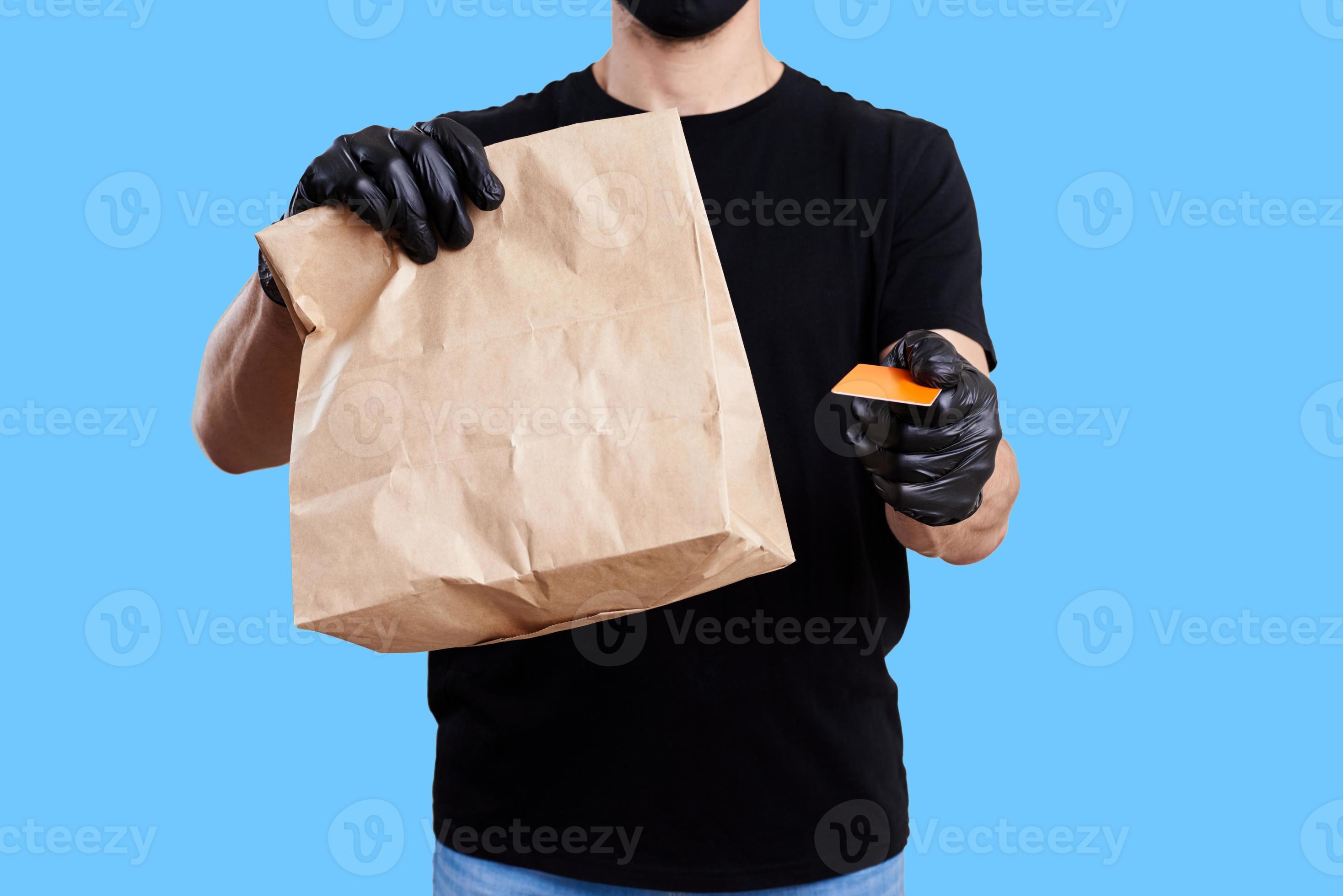 Delivery man hold paper bag with food. Food delivery concept 14264100