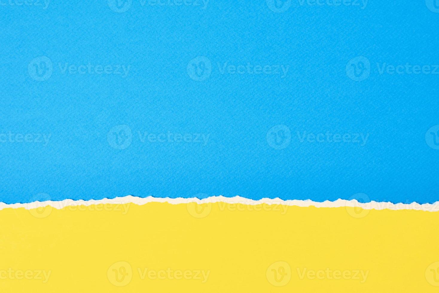 Torn ripped paper edge with a copy space, color blue and yellow background photo