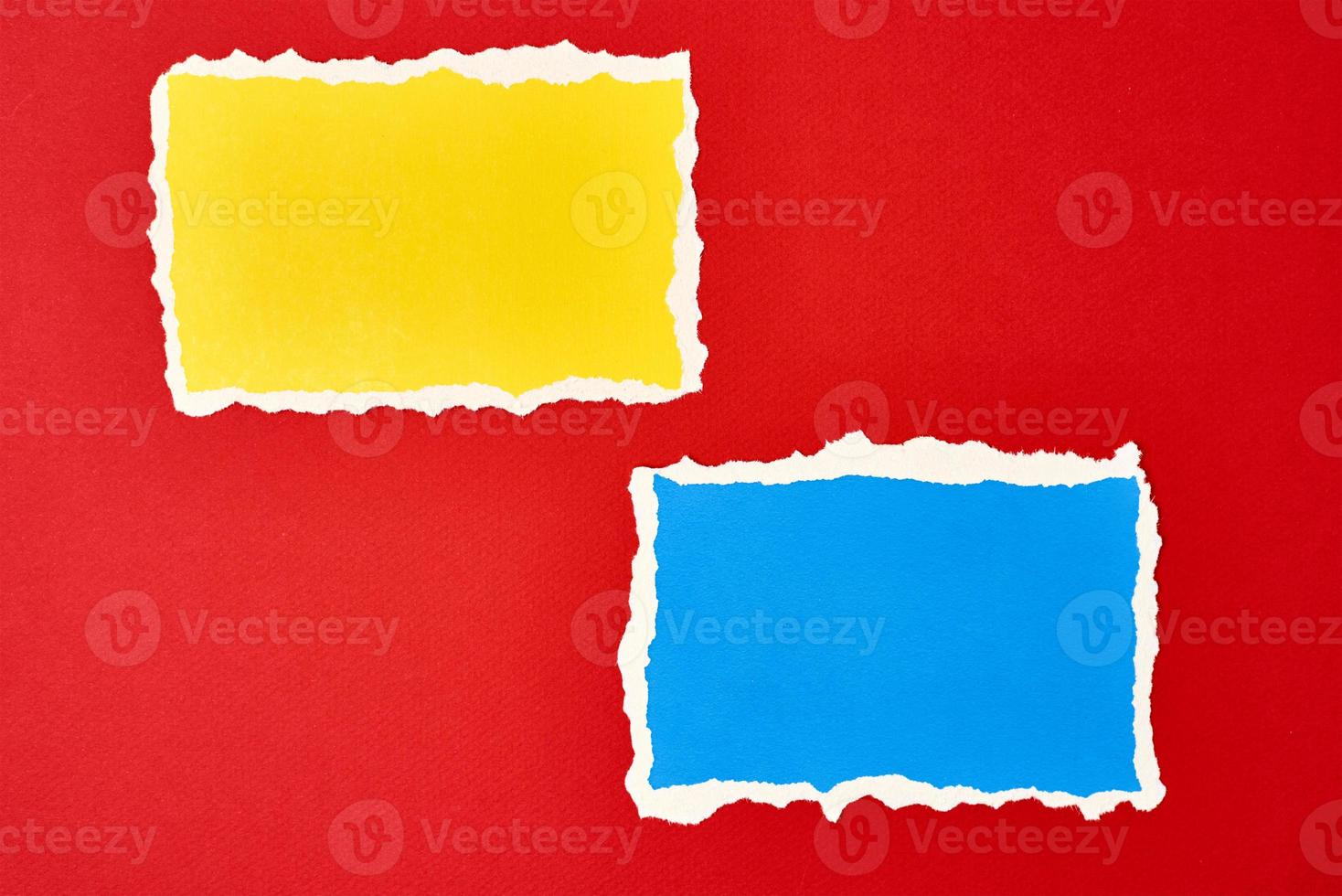 Two ripped paper torn edge sheets on a red background. photo