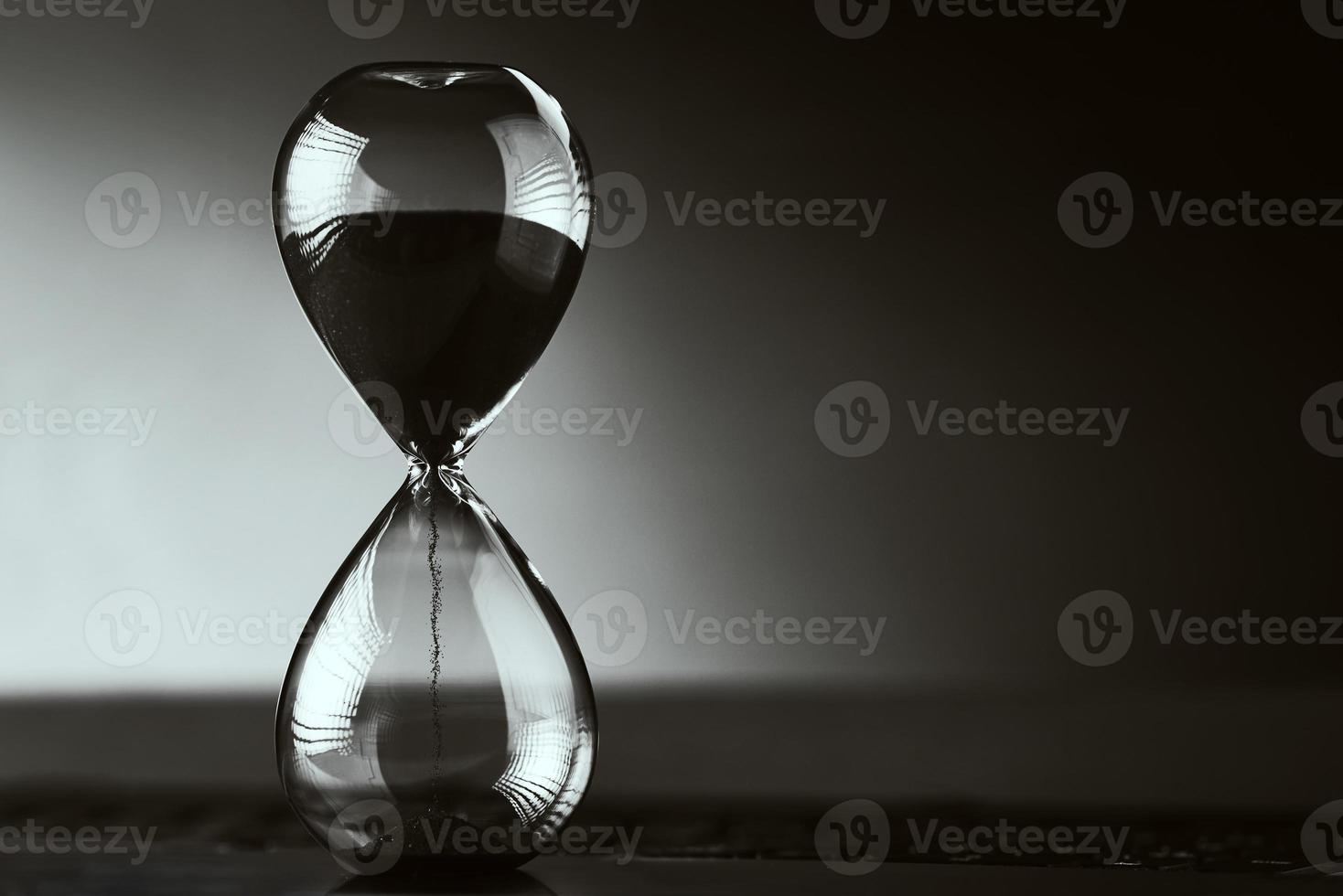 Hourglass on the dark background with copy space. photo