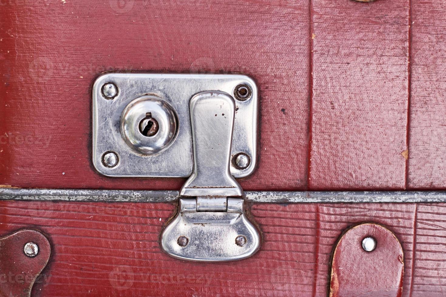 Part of vintage retro suitcase. Closeup view of lock on old suit case photo