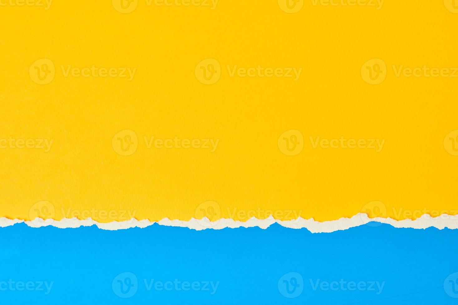 Torn ripped paper edge with a copy space, color blue and yellow background photo