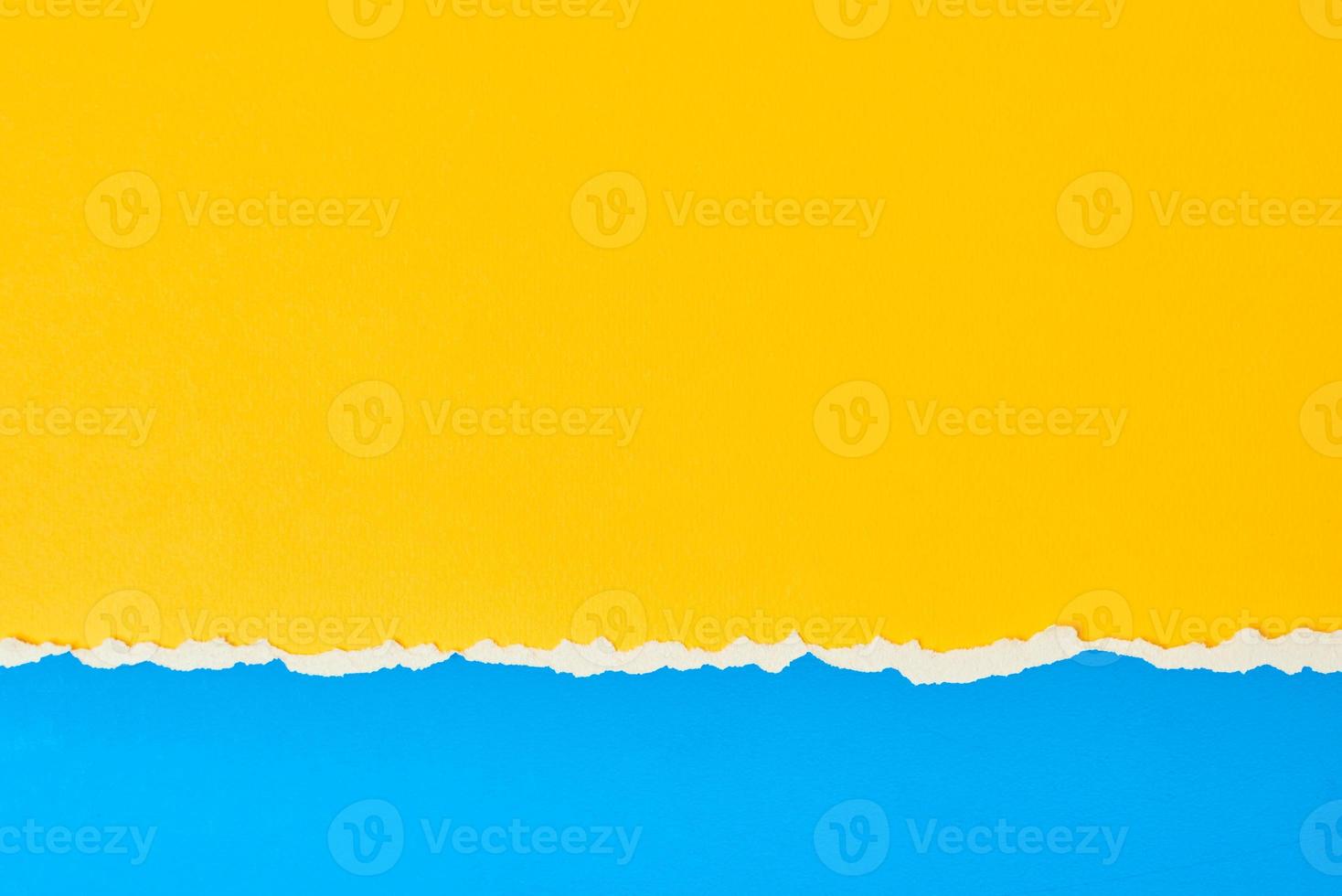 Torn ripped paper edge with a copy space, color blue and yellow background photo