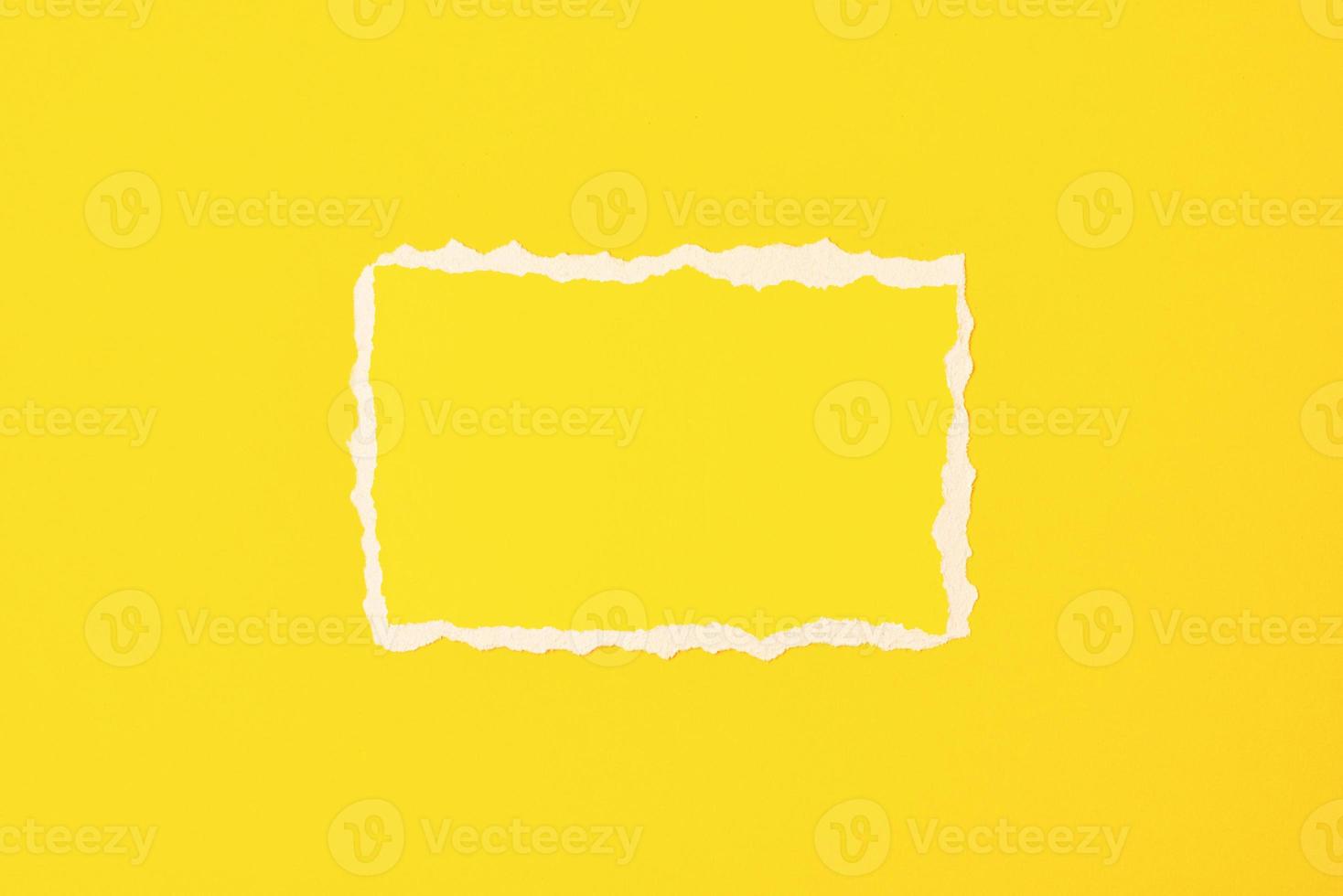 Torn ripped paper edge frame on a yellow background photo