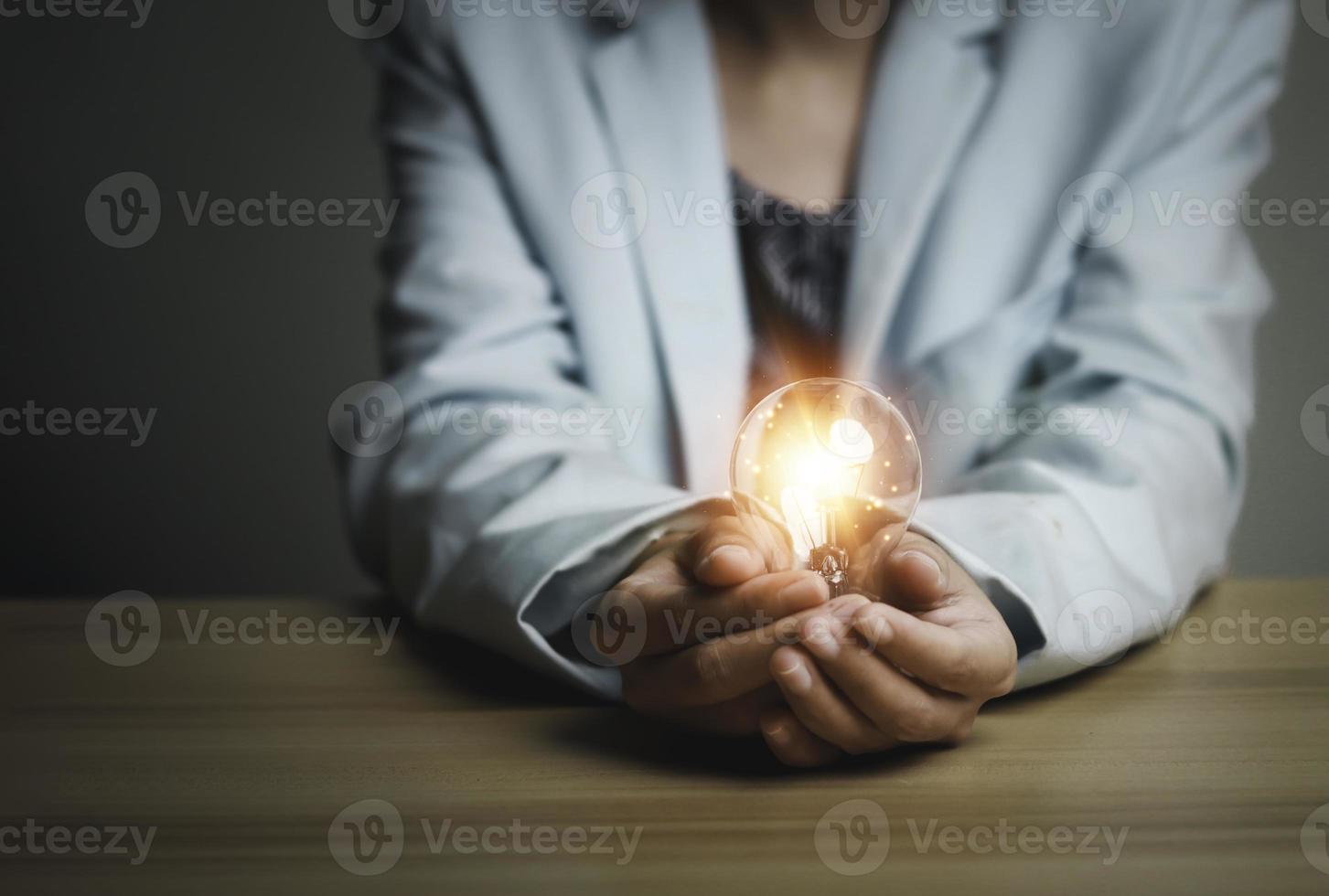 Businesswoman holding a light bulb, Creative new idea. Innovation, brainstorming, solution and inspiration concepts. imagination, creative thinking problem solving. photo